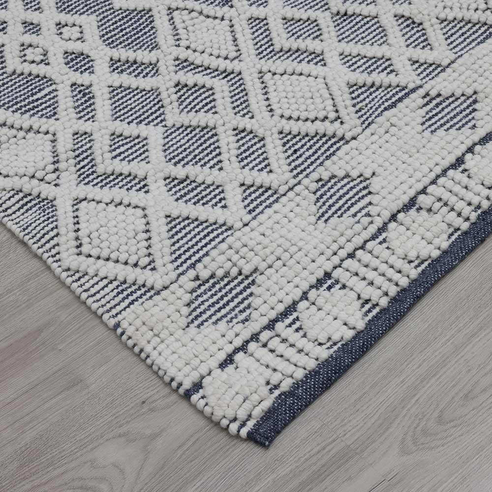 Close-up of a geometric patterned rug on a wooden floor