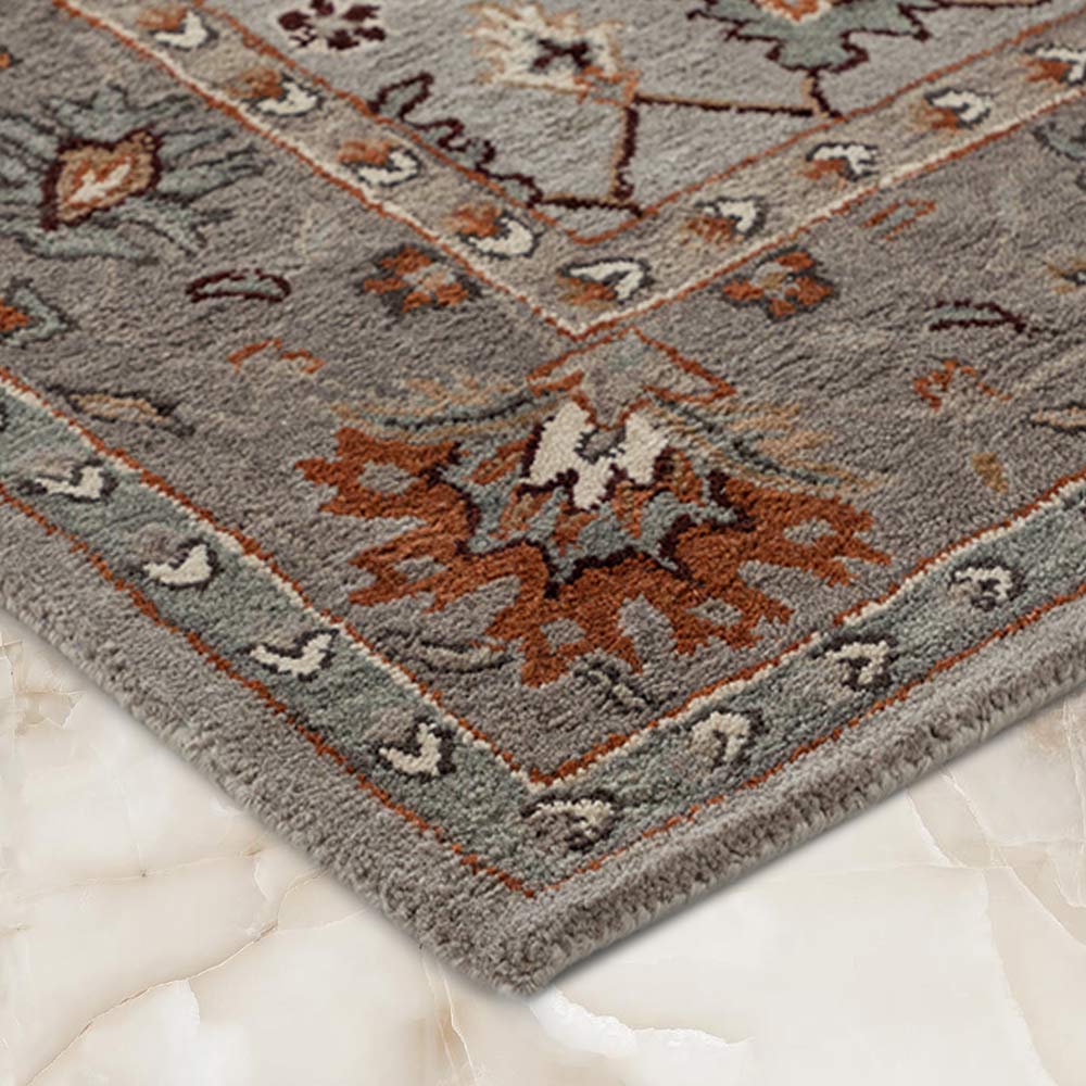 Decorative rug with intricate patterns on a marble floor