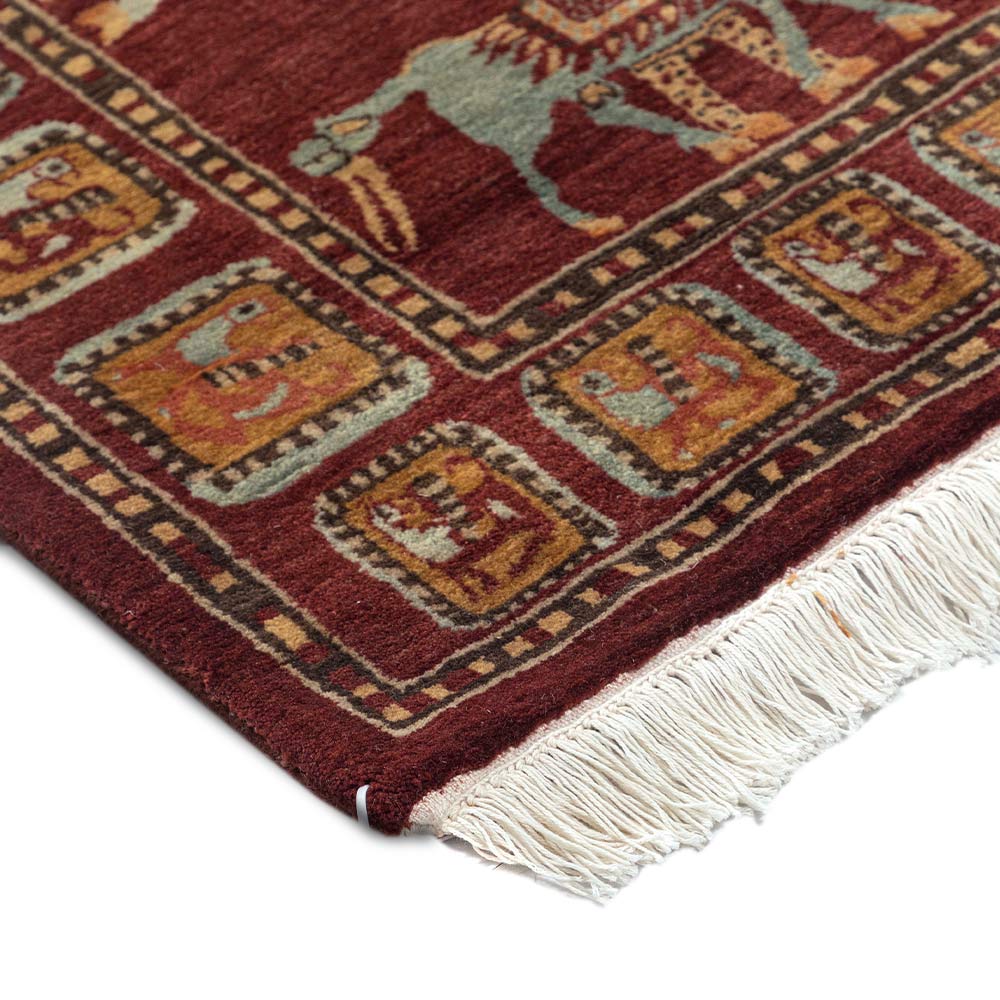 Close-up of a patterned rug with fringes on a white background