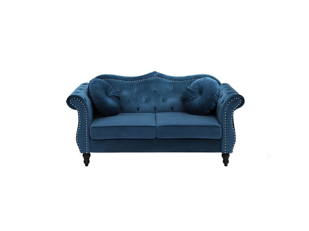 Blue velvet sofa with studded details on a white background