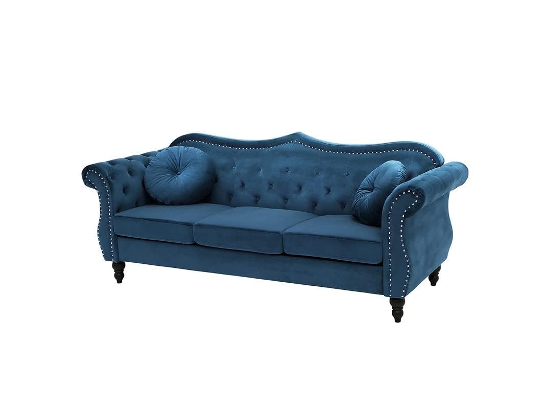 Blue sofa with tufted backrest and nailhead trim on a white background