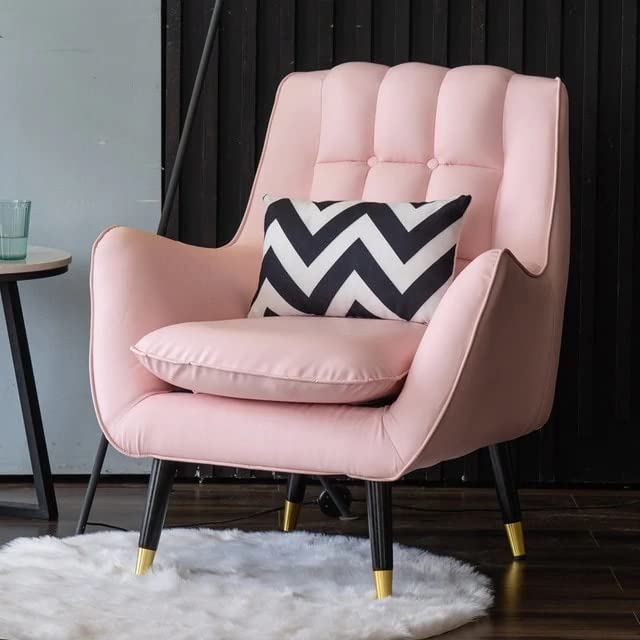 Pink armchair with a black and white chevron pillow on a white rug.