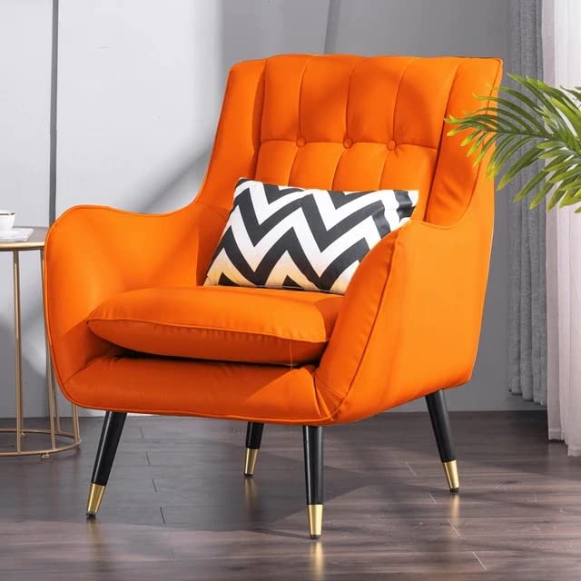 Orange armchair with a black and white chevron pillow in a room setting.
