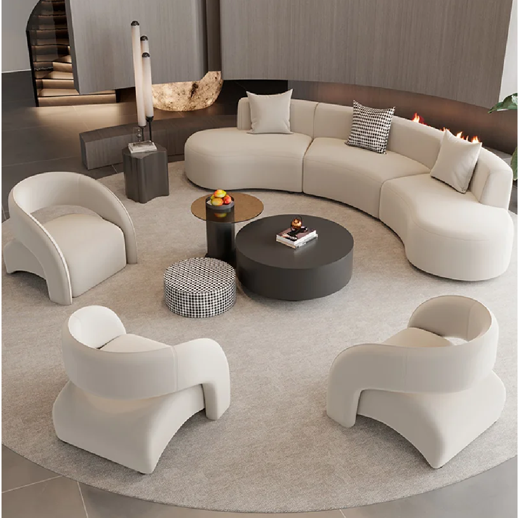Modern living room with a curved beige sofa, white armchairs, and a round coffee table.