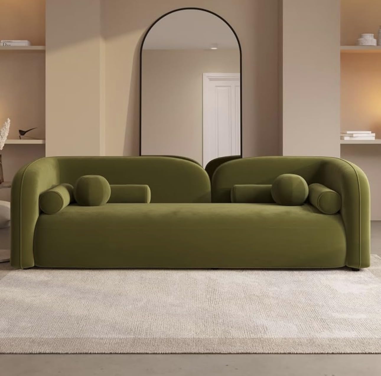 Modern green sofa in a room with a mirror and shelves.
