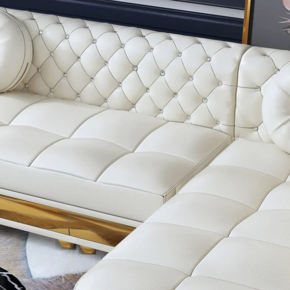 White tufted sofa with gold accents in a room setting