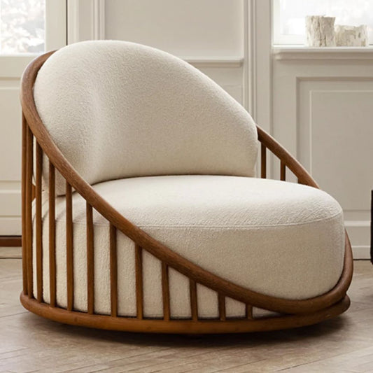Modern chair with wooden frame and white cushion in a room with large windows.
