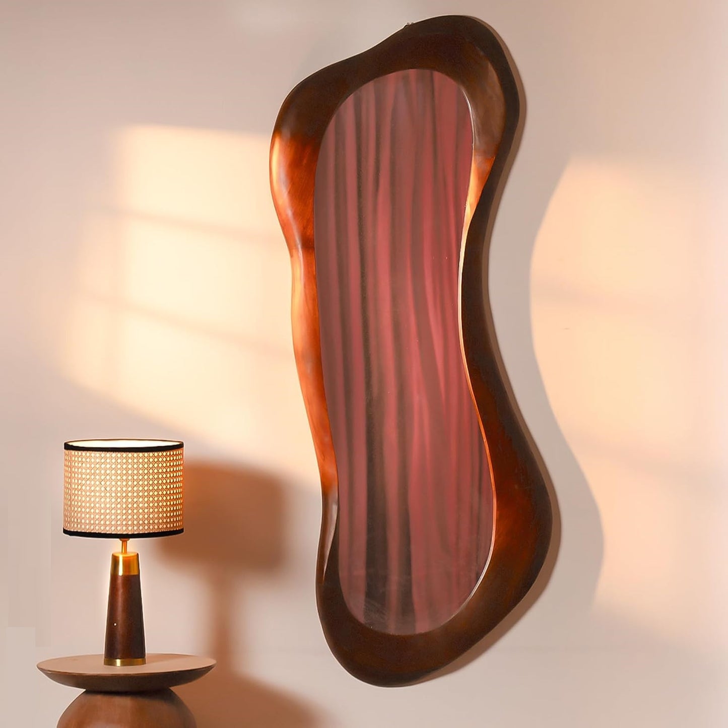 Wavy mirror with a table lamp on a neutral background