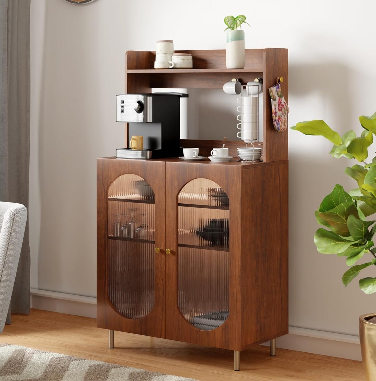 Wooden kitchen cabinet with glass doors containing kitchen appliances and items, placed against a neutral wall.
