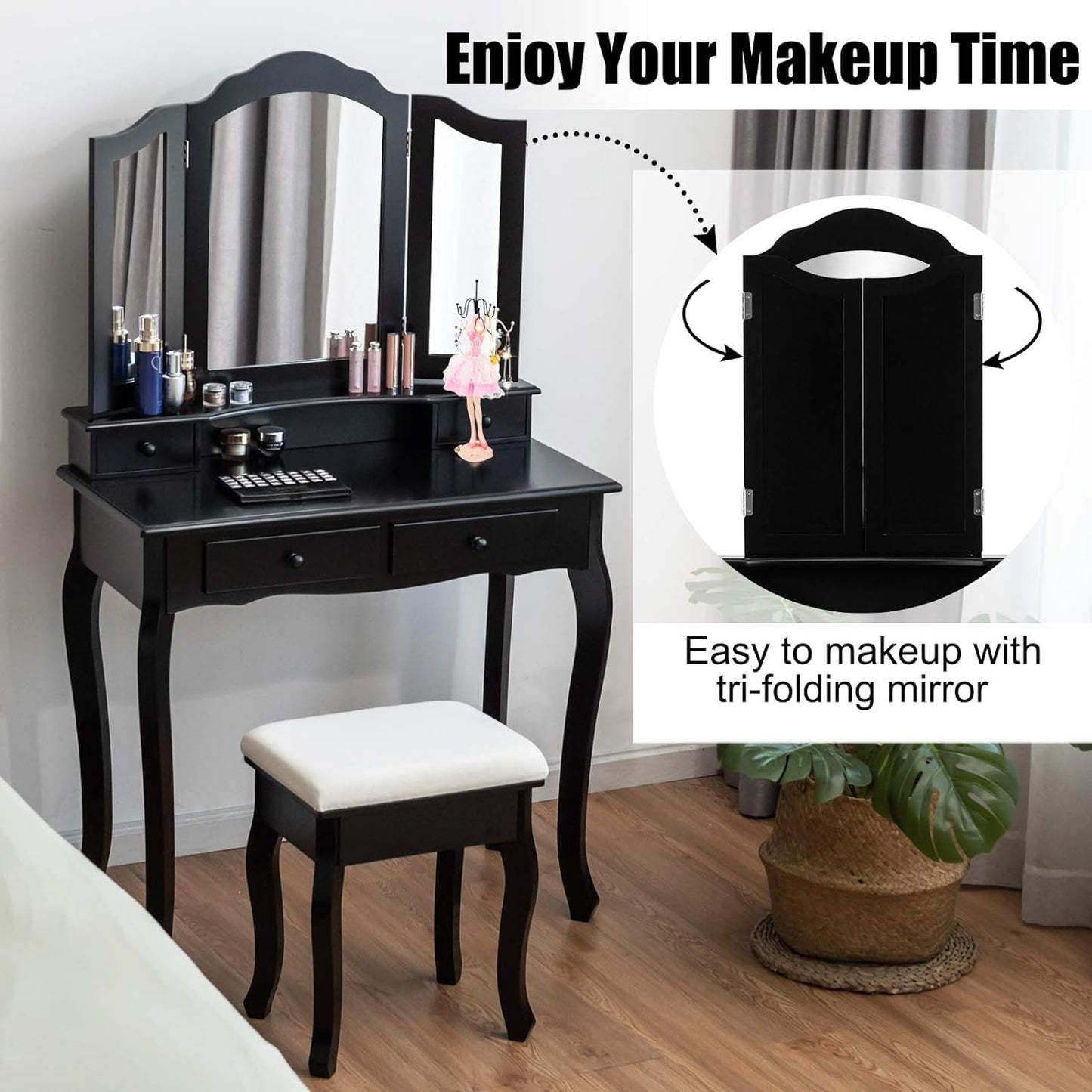 Black makeup vanity table with tri-folding mirror and stool in a room setting.