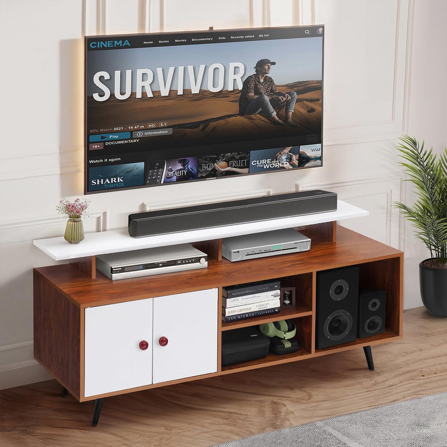 Wooden TV stand with a television displaying the show 'Survivor' and a soundbar.
