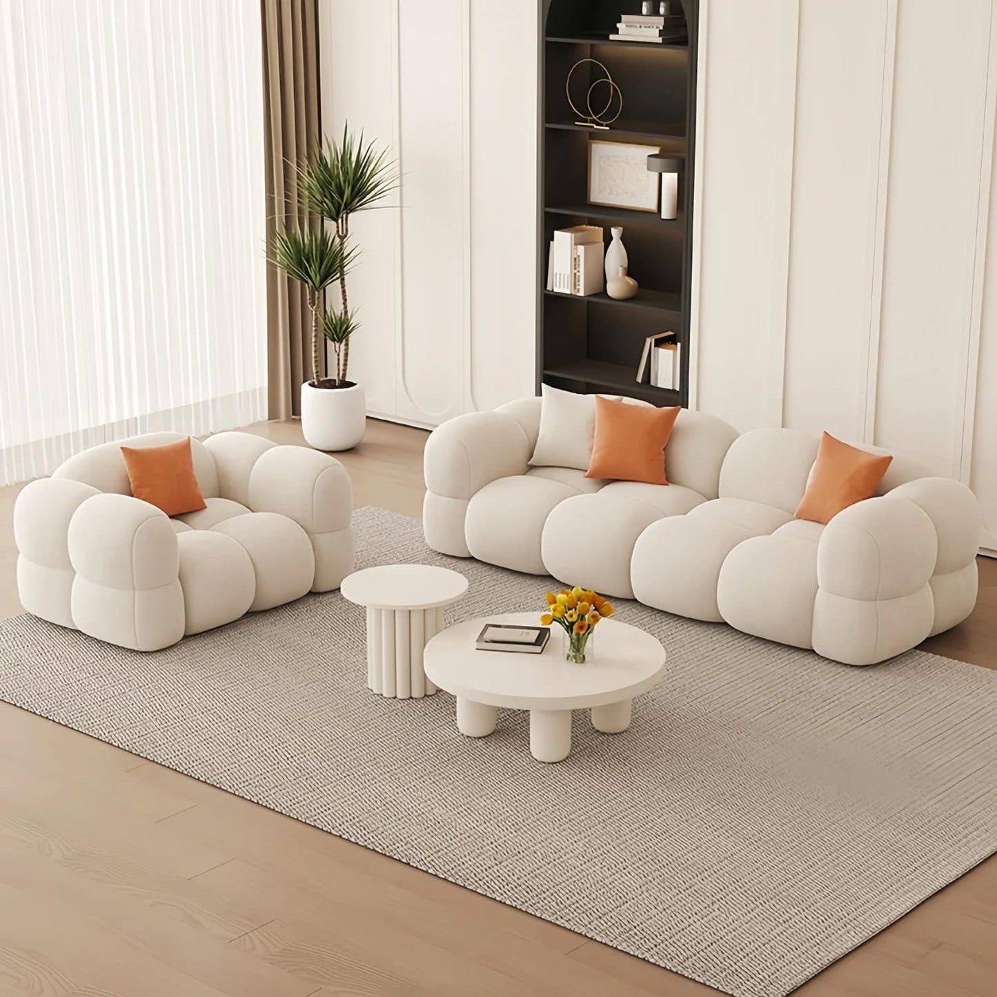 Modern living room with a white bubble-style sofa set, coffee table, and decorative elements.