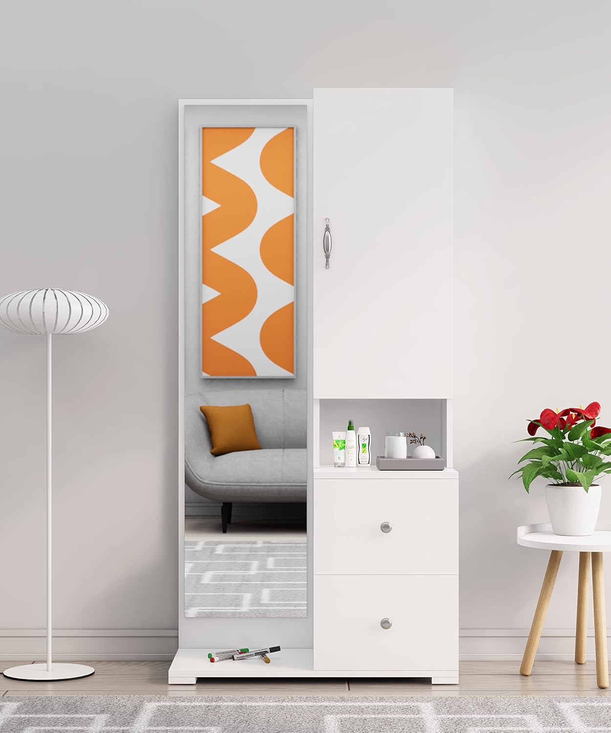 White wardrobe with mirror in a room with a lamp, plant, and small table.
