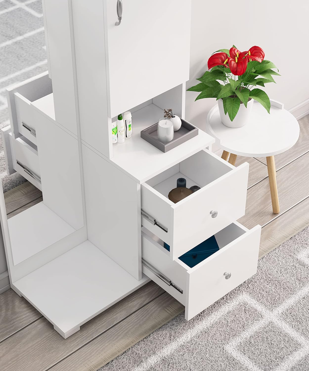 White storage unit with open drawers and a small table with a plant on a wooden floor.