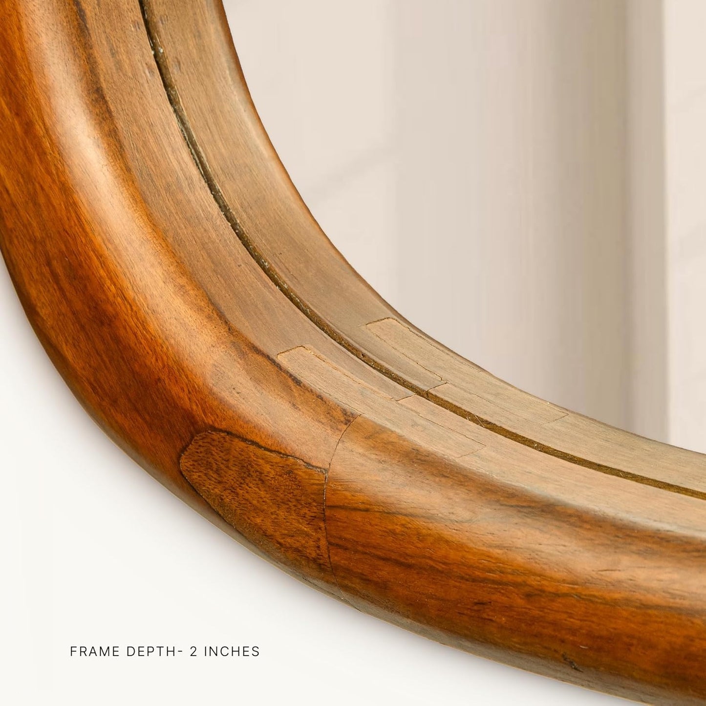 Close-up of a wooden mirror frame with a plain background