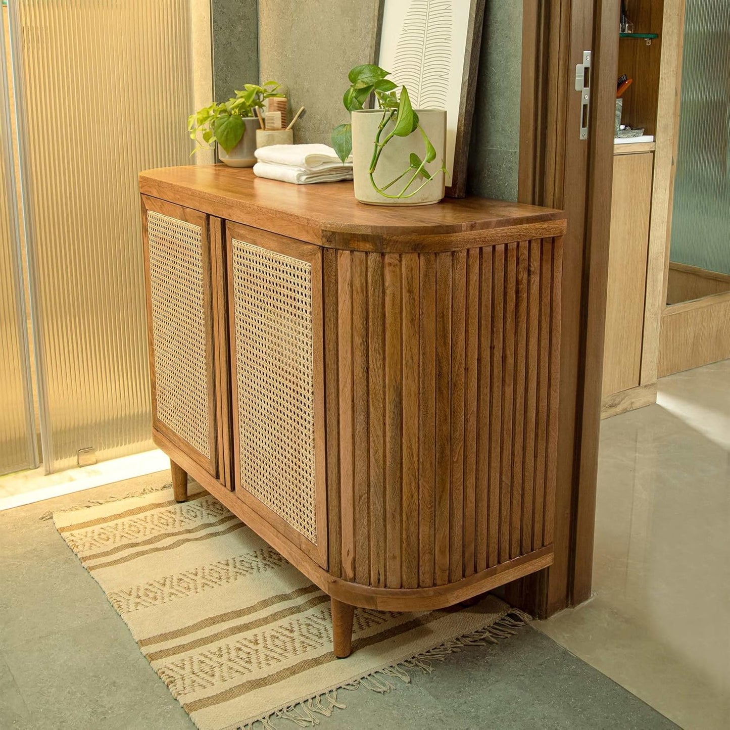 Wooden sideboard with wicker doors in a room setting
