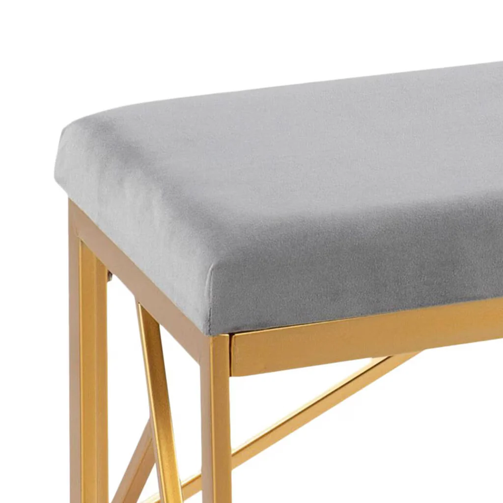 Gray cushioned bench with gold metal frame on a white background