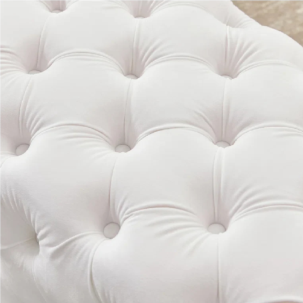 Close-up of a tufted white headboard