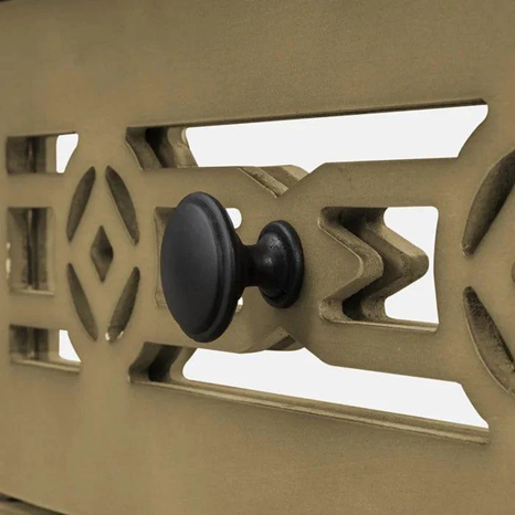 Close-up of a mechanical device with a black knob on a beige background