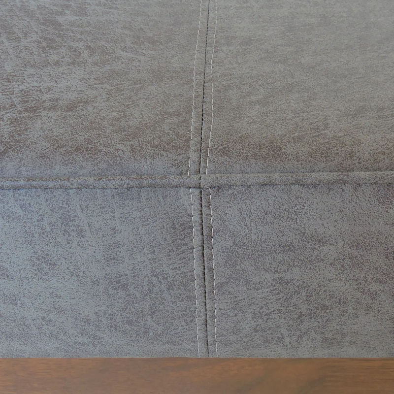 Close-up of gray tiles with a wooden floor at the bottom