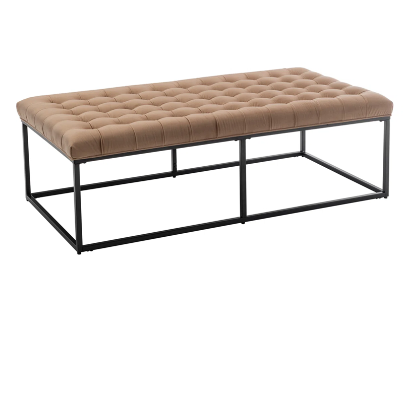 Beige tufted bench with black metal frame on a white background