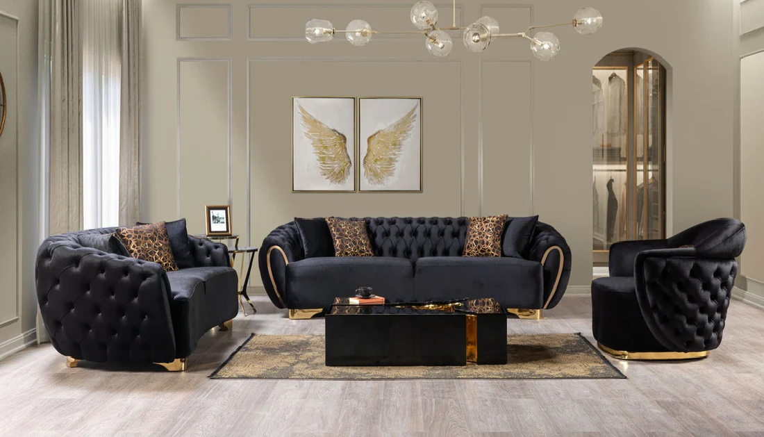 Modern living room with black tufted sofa set and decorative elements.