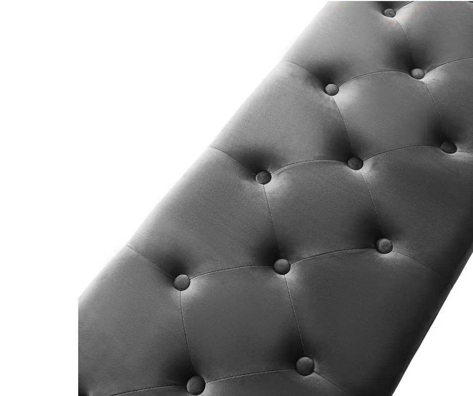 Gray tufted headboard with button details on a white background