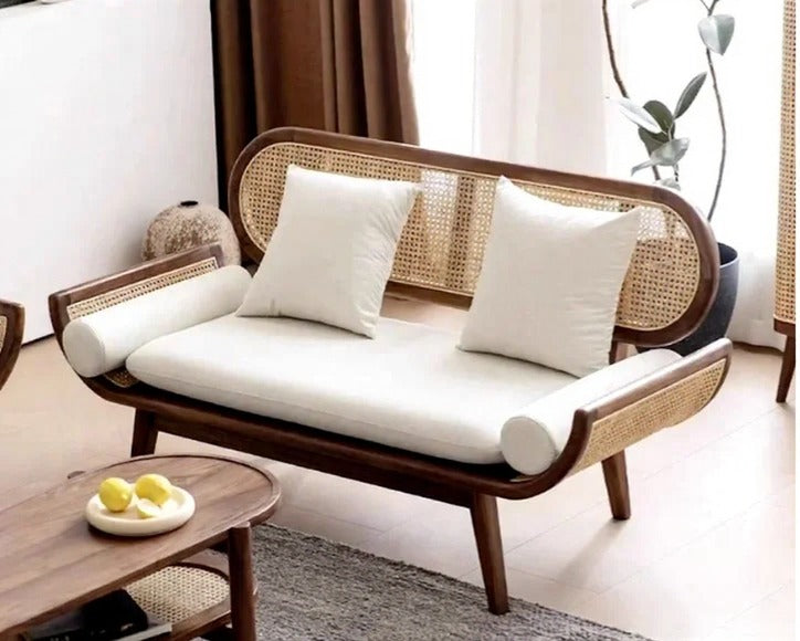 Wicker chair with white cushions in a living room setting