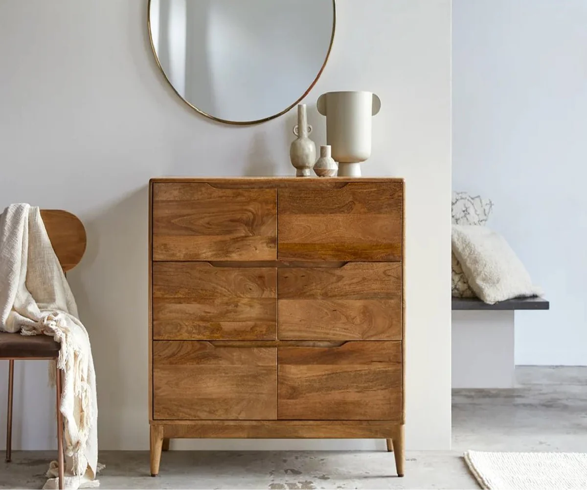 Wooden dresser with decorative items in a room setting
