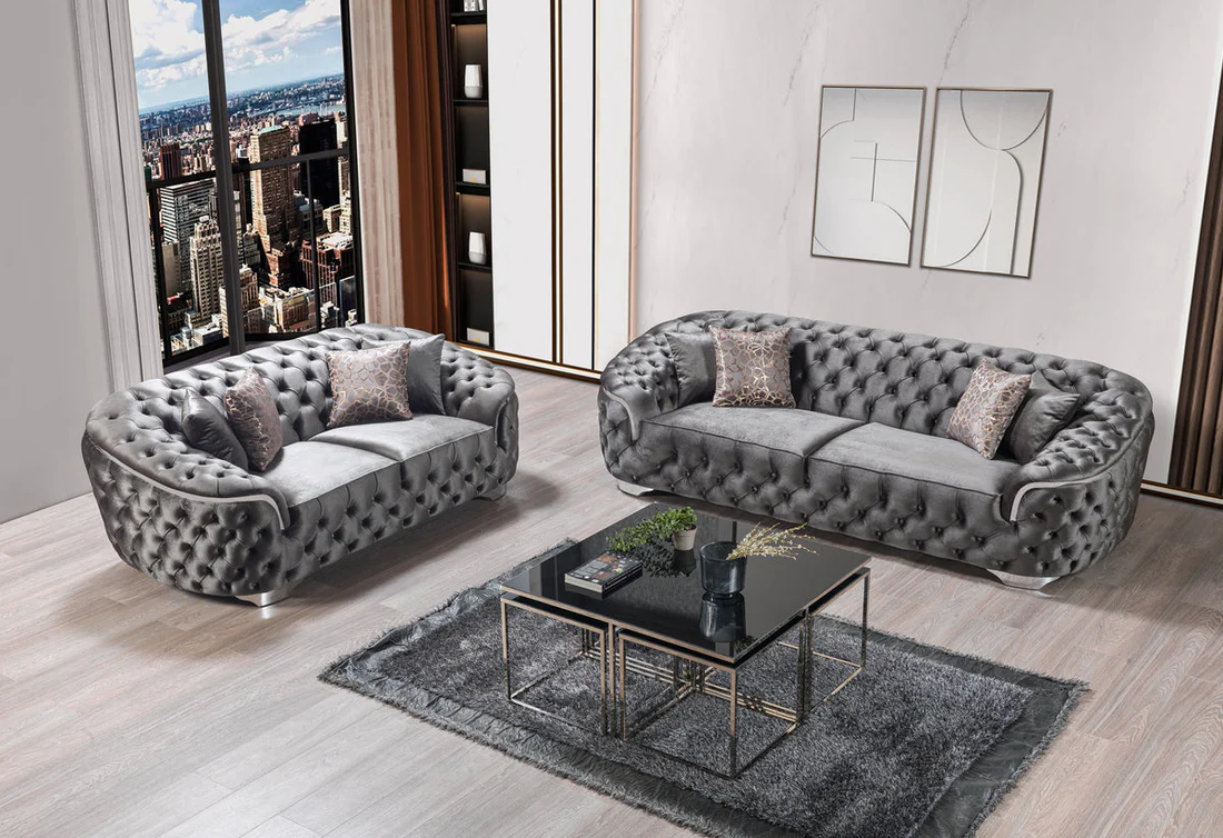 Gray tufted sofa set in a modern living room with cityscape view