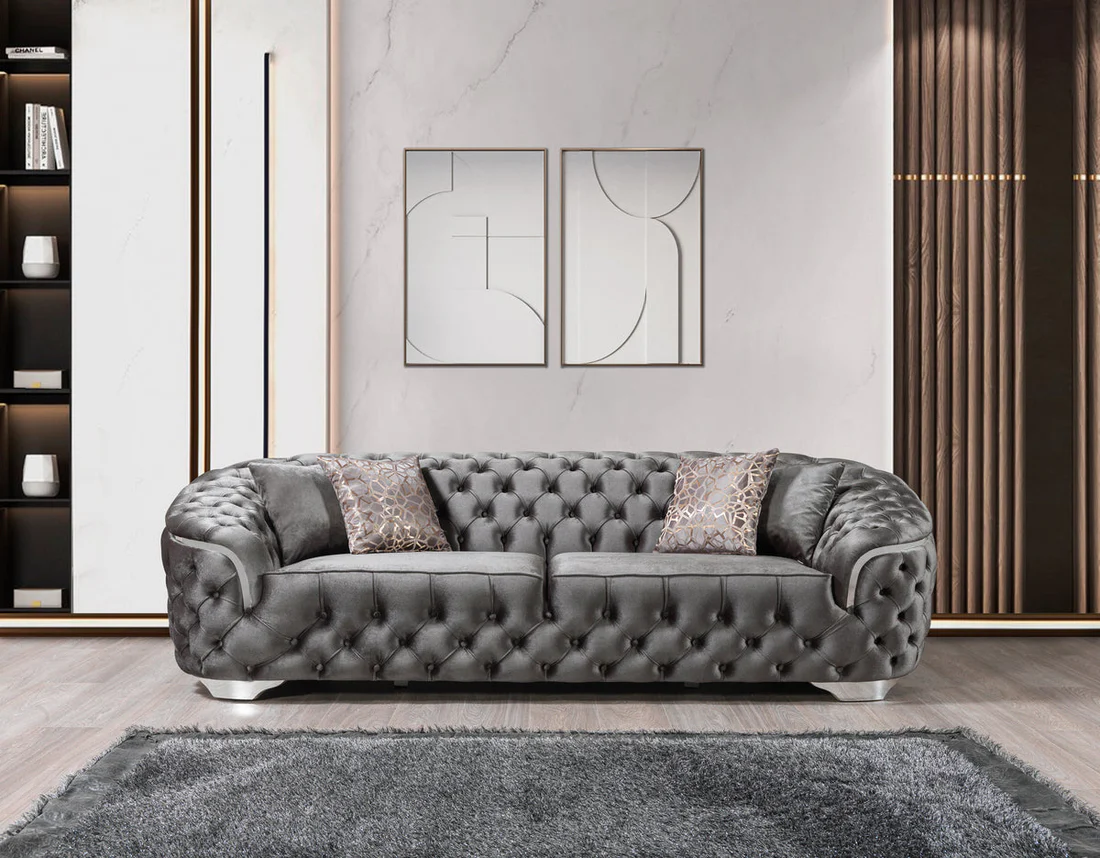 Gray tufted sofa in a modern living room with abstract art on the wall.