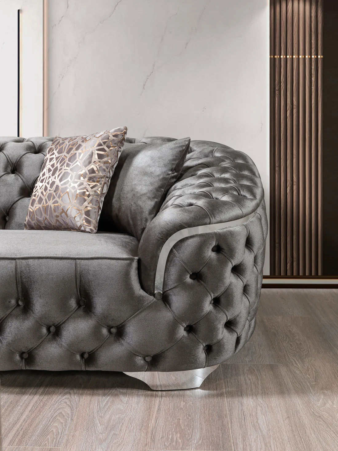 Gray tufted sofa with decorative pillows in a modern interior setting.