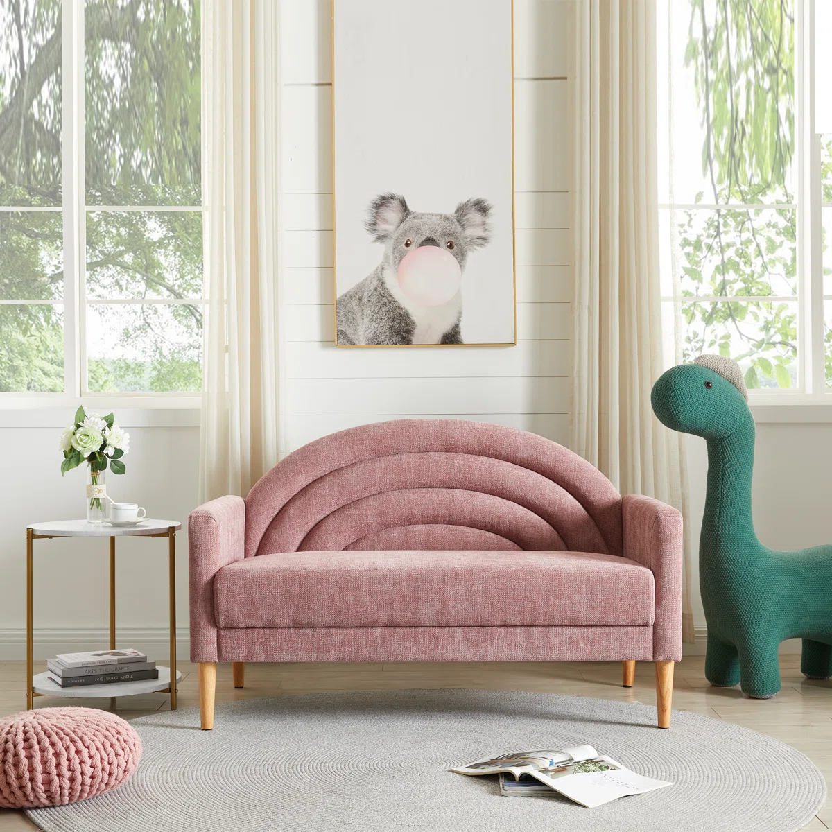 Pink children's sofa in a room with a dinosaur toy and a koala painting on the wall.