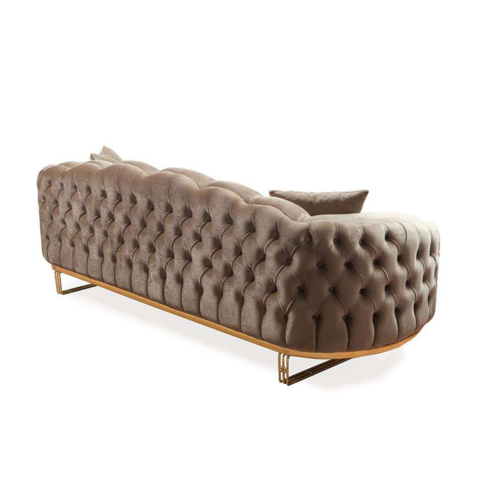 Brown tufted sofa with gold legs on a white background