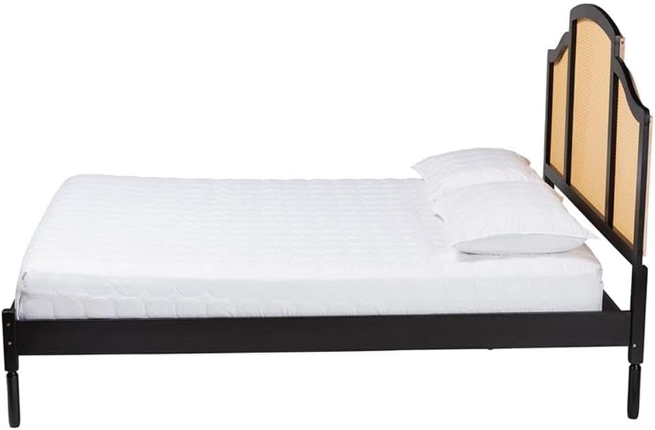 Bed with black metal frame and wooden headboard on a white background