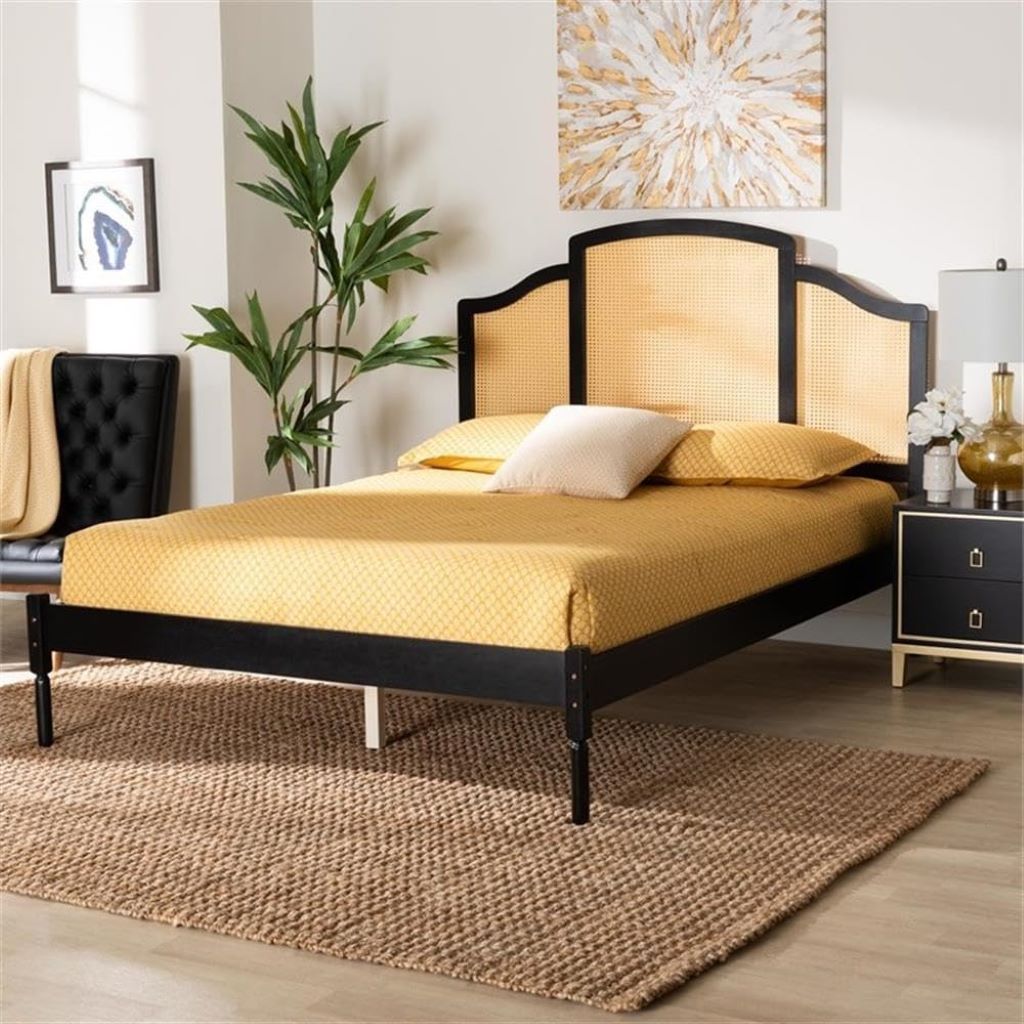 Bedroom with a black and gold bed frame, yellow bedding, and decorative elements.