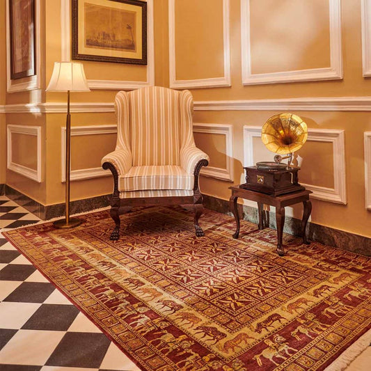 Vintage-style room with striped armchair, gramophone, and patterned rug.