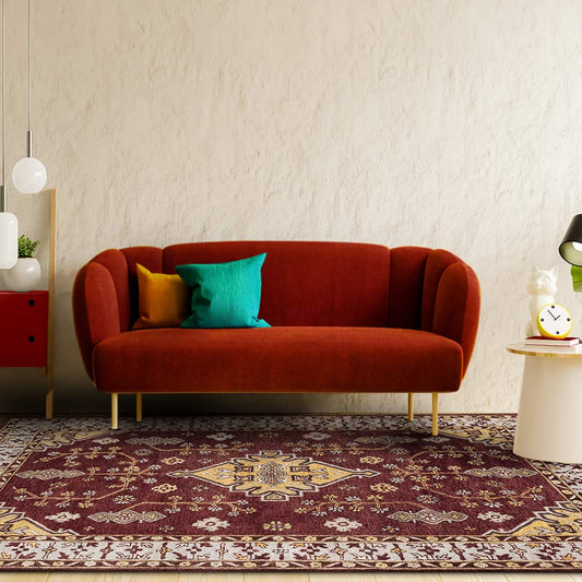 Red sofa with colorful cushions in a living room setting