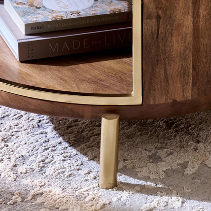 Wooden coffee table with gold legs on a textured surface