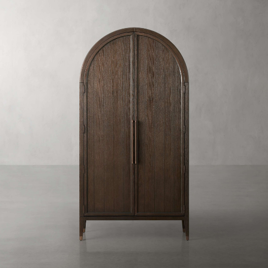 Wooden armoire with curved top on a gray background