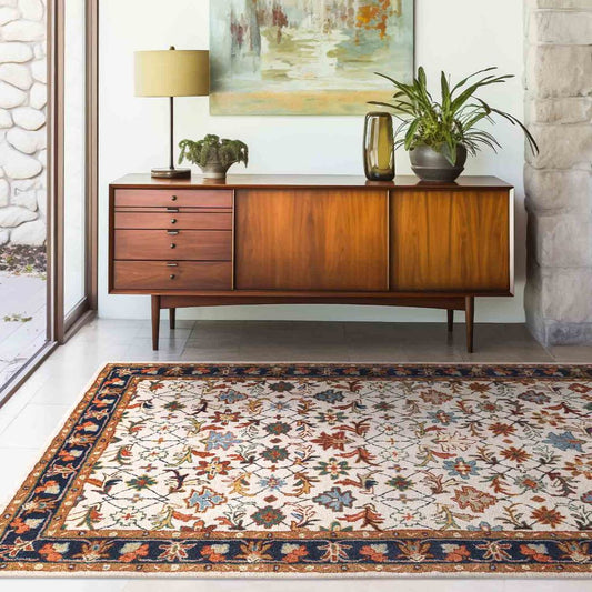 Wooden sideboard with decorative items in a room with a patterned rug.