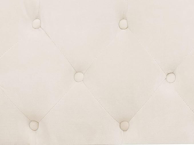 Close-up of a tufted white cushion with button details