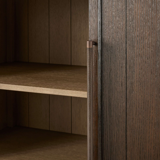 Wooden cabinet with a metal handle in a dimly lit setting