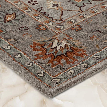 Decorative rug with intricate patterns on a marble floor
