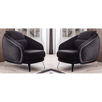 Two black armchairs with quilted design in a room setting.