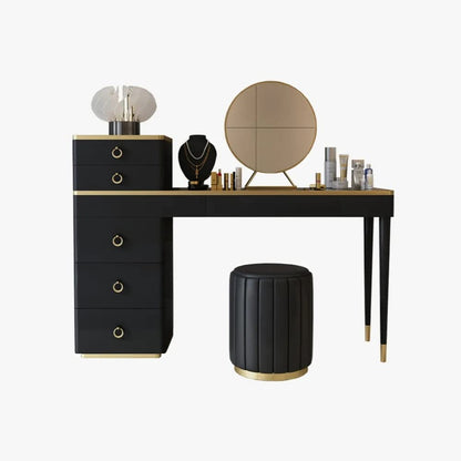 Black vanity table with gold accents, mirror, and stool on a white background