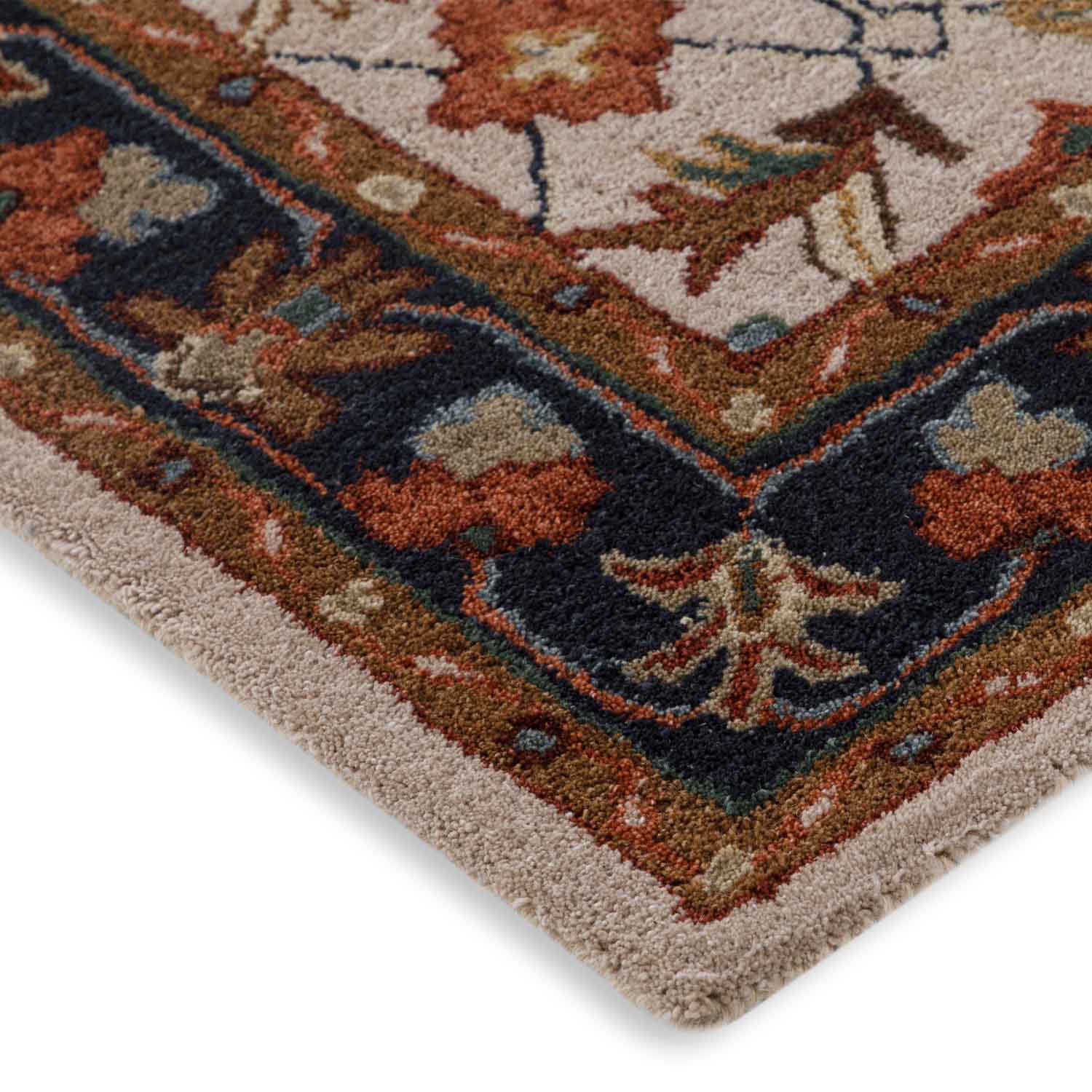 Close-up of a patterned rug with floral designs on a white background