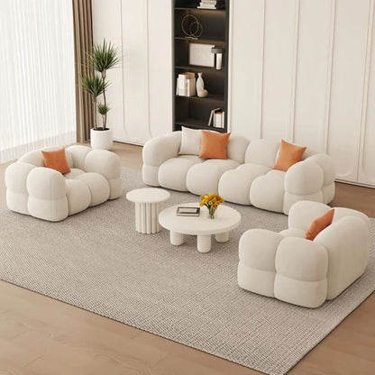 Modern living room with white bubble-style sofa and orange cushions