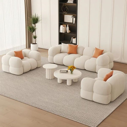 Modern living room with white bubble-style sofa and orange cushions