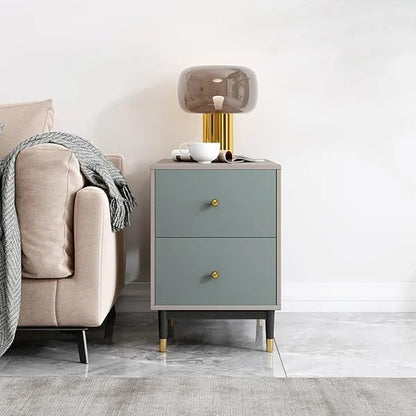 Gray nightstand with gold accents next to a beige sofa in a modern living room.